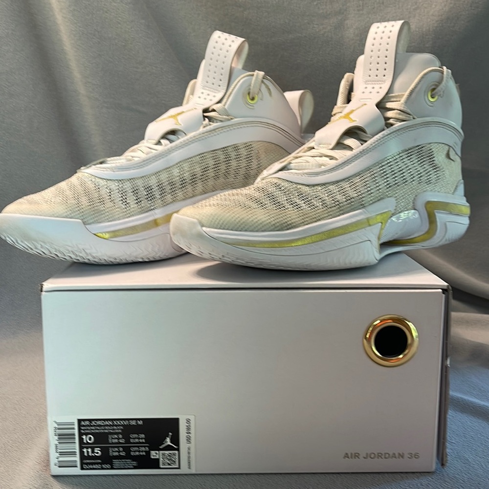 Used Air Jordan basketball shoes. White and gold.